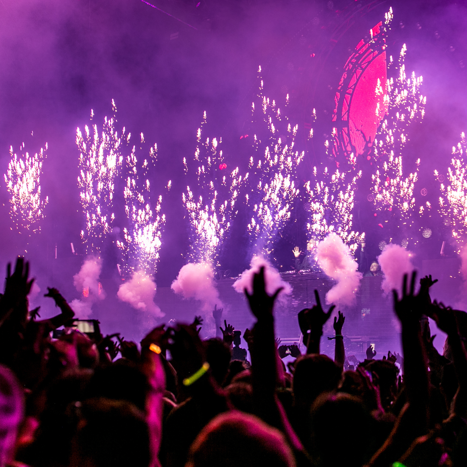 Live entertainment stage with purple lighting and fireworks